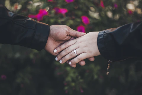 person in black long sleeve shirt with gold ring