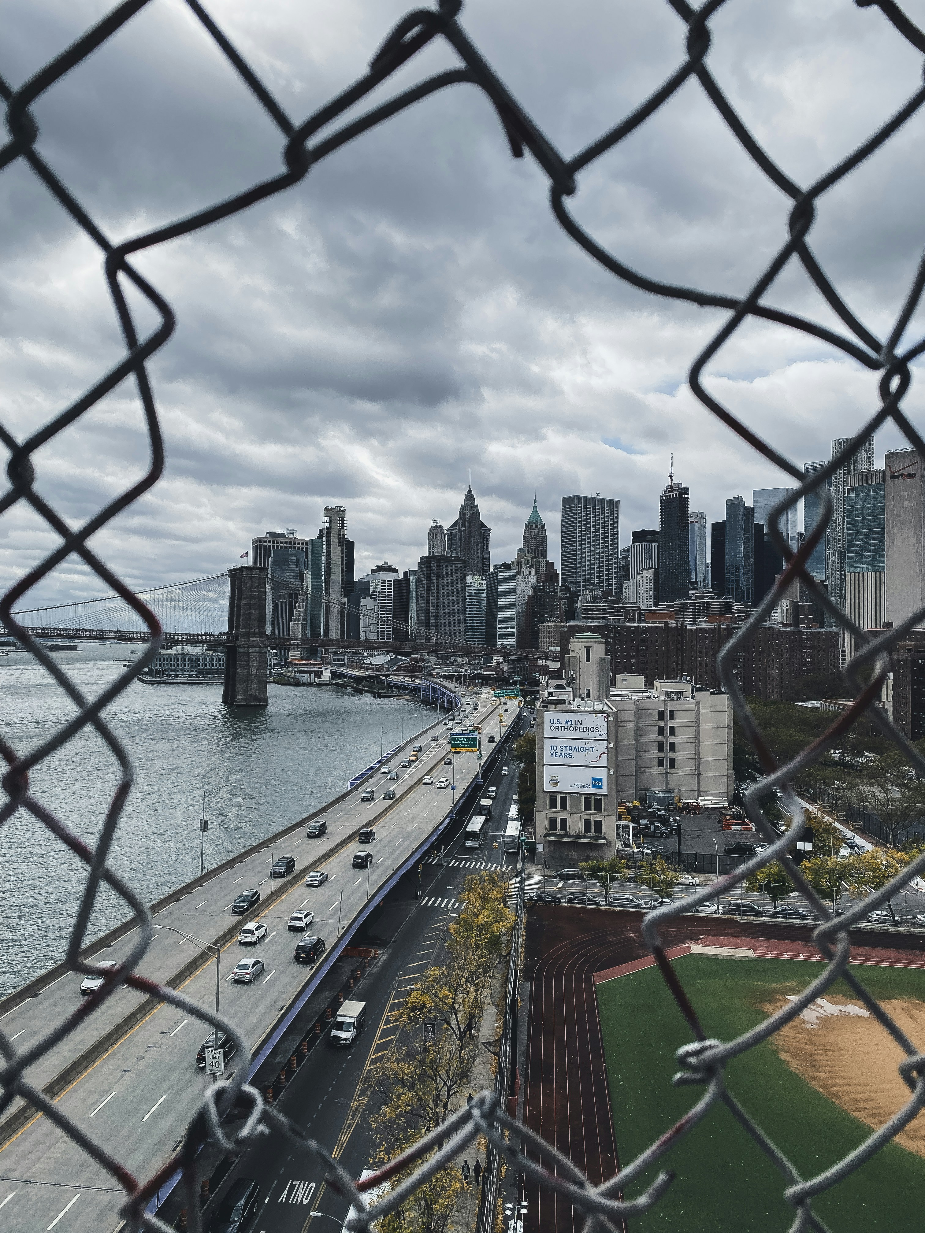 city skyline near body of water under cloudy sky during daytime