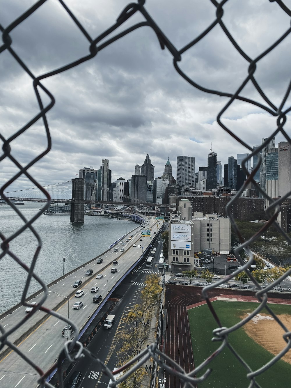 city skyline near body of water under cloudy sky during daytime