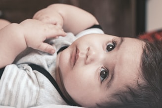 baby in white and pink shirt