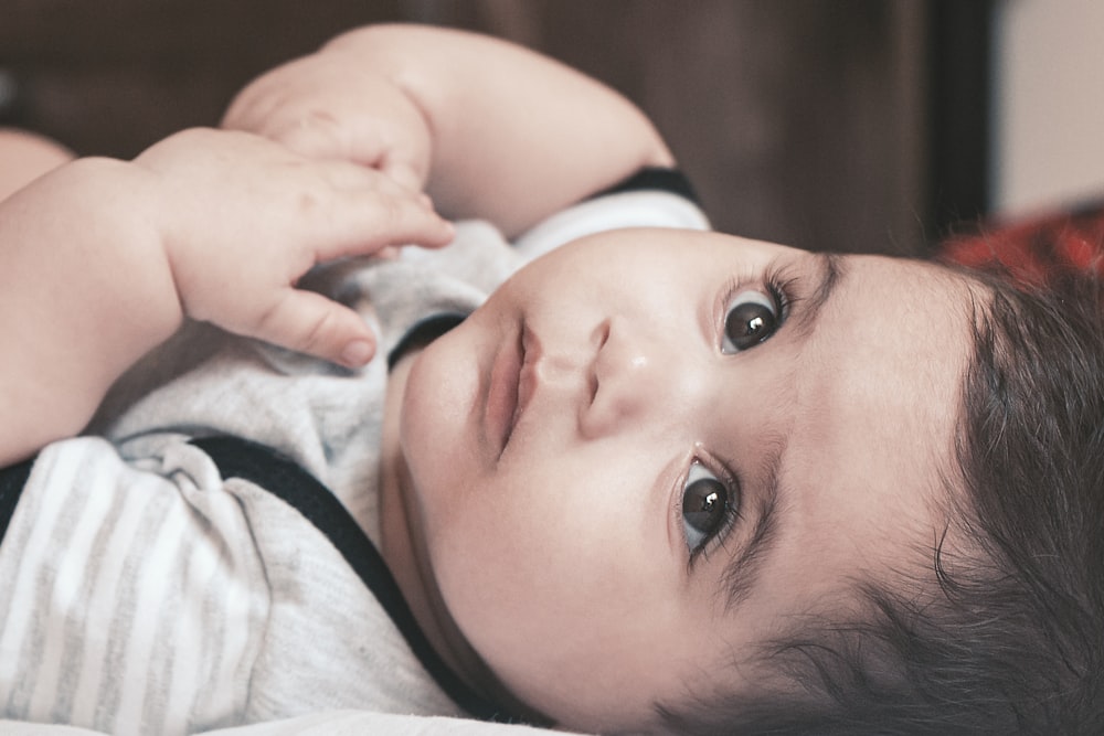 baby in white and pink shirt