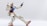 A highly detailed model of a robot with a white body, blue chest, red accents, and articulated joints in a dynamic pose against a plain background.