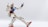 A highly detailed model of a robot with a white body, blue chest, red accents, and articulated joints in a dynamic pose against a plain background.