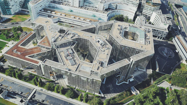 An aerial view of a sophisticated architectural complex blending concrete and wood elements