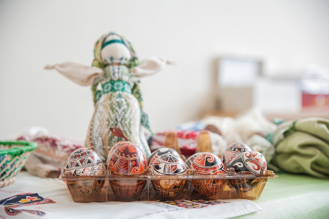 red and white ceramic figurine on brown woven basket