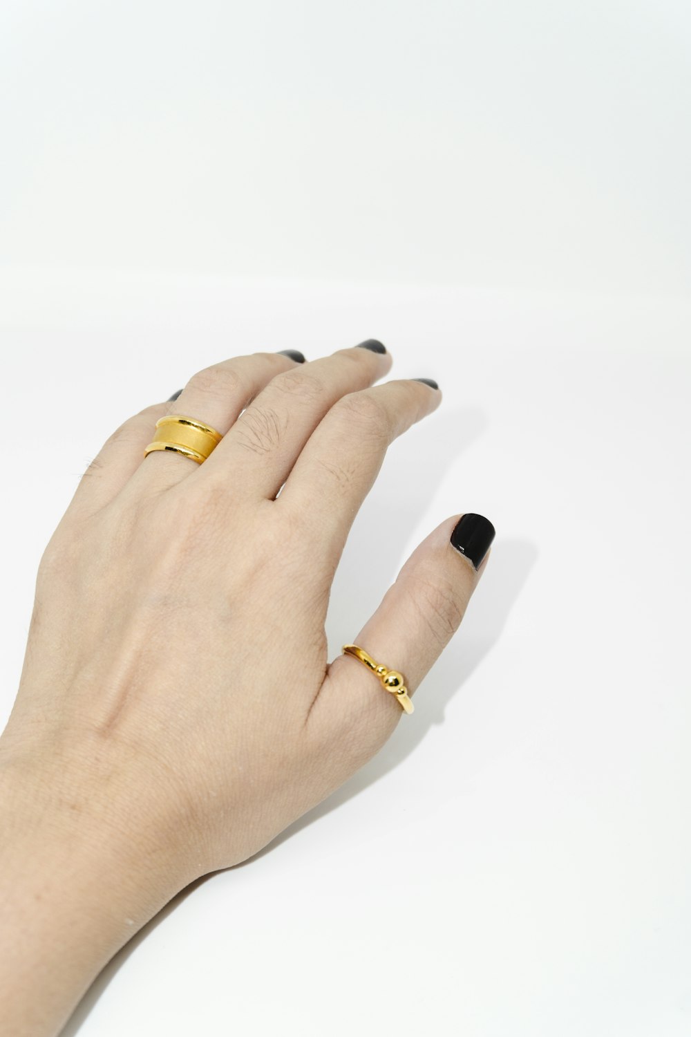 woman wearing gold ring and gold ring