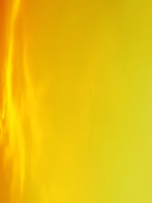 Sunset gradient nails blending orange, pink, and yellow hues with a matte finish.