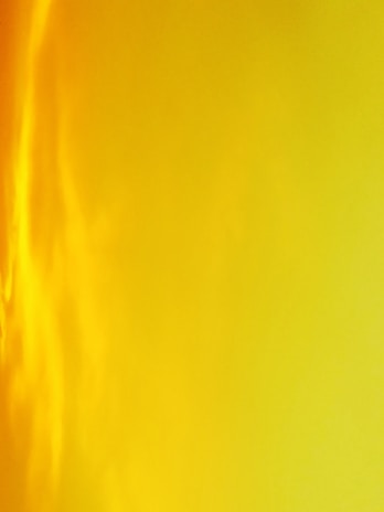 Sunset-inspired gradient nails blending warm oranges and reds with a glossy shine.