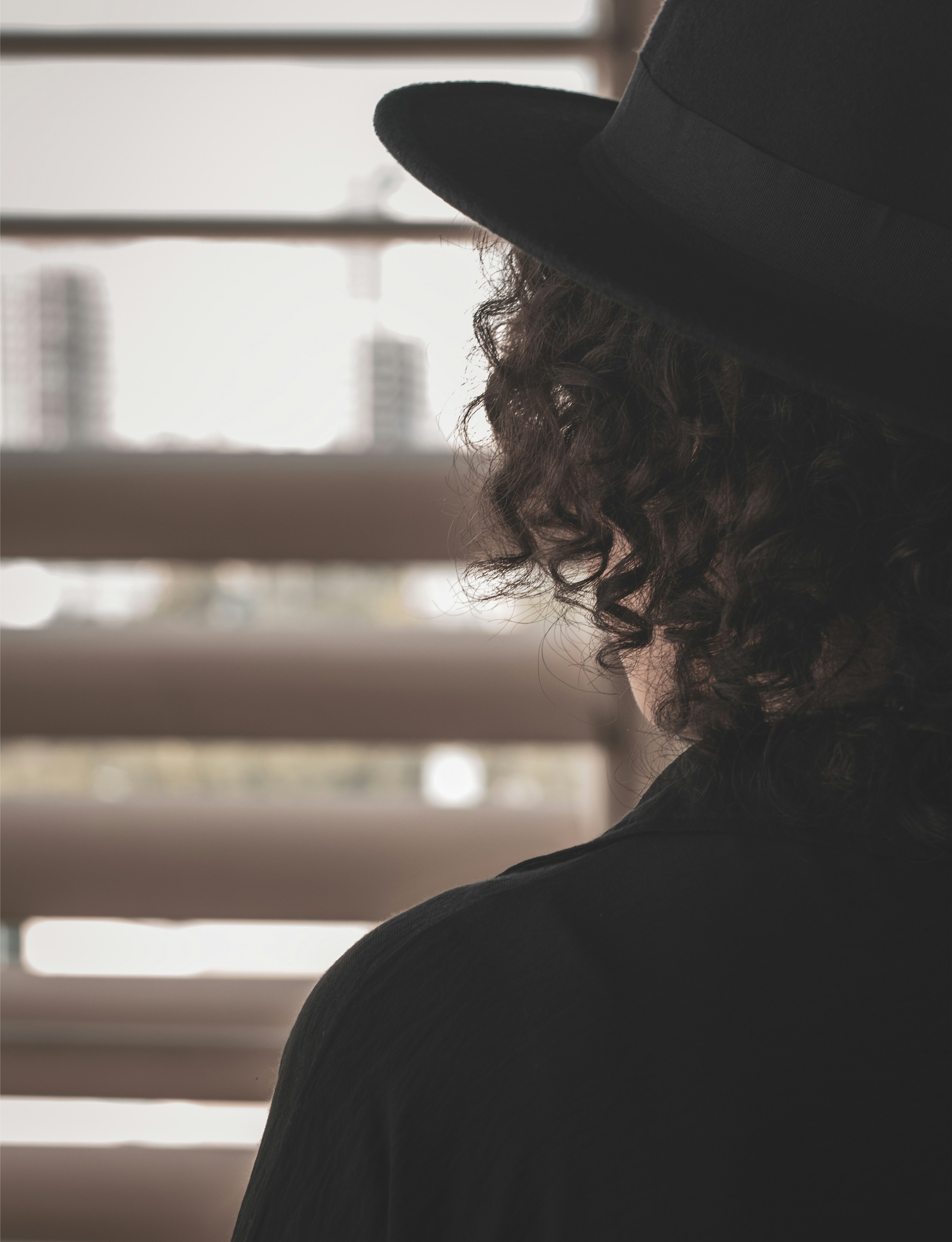 woman in black shirt wearing black hat