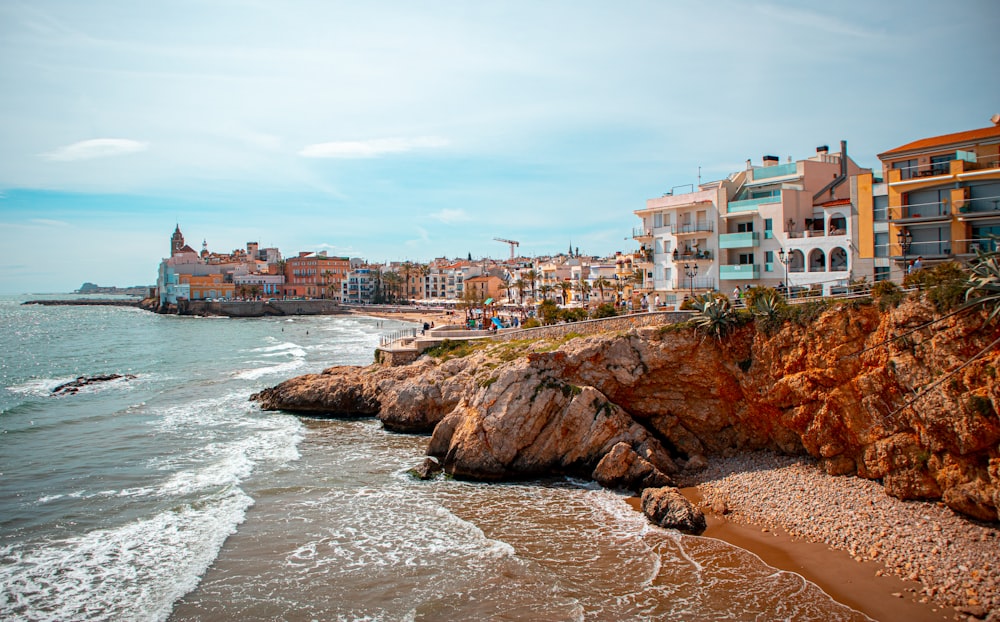 people on beach near buildings during daytime