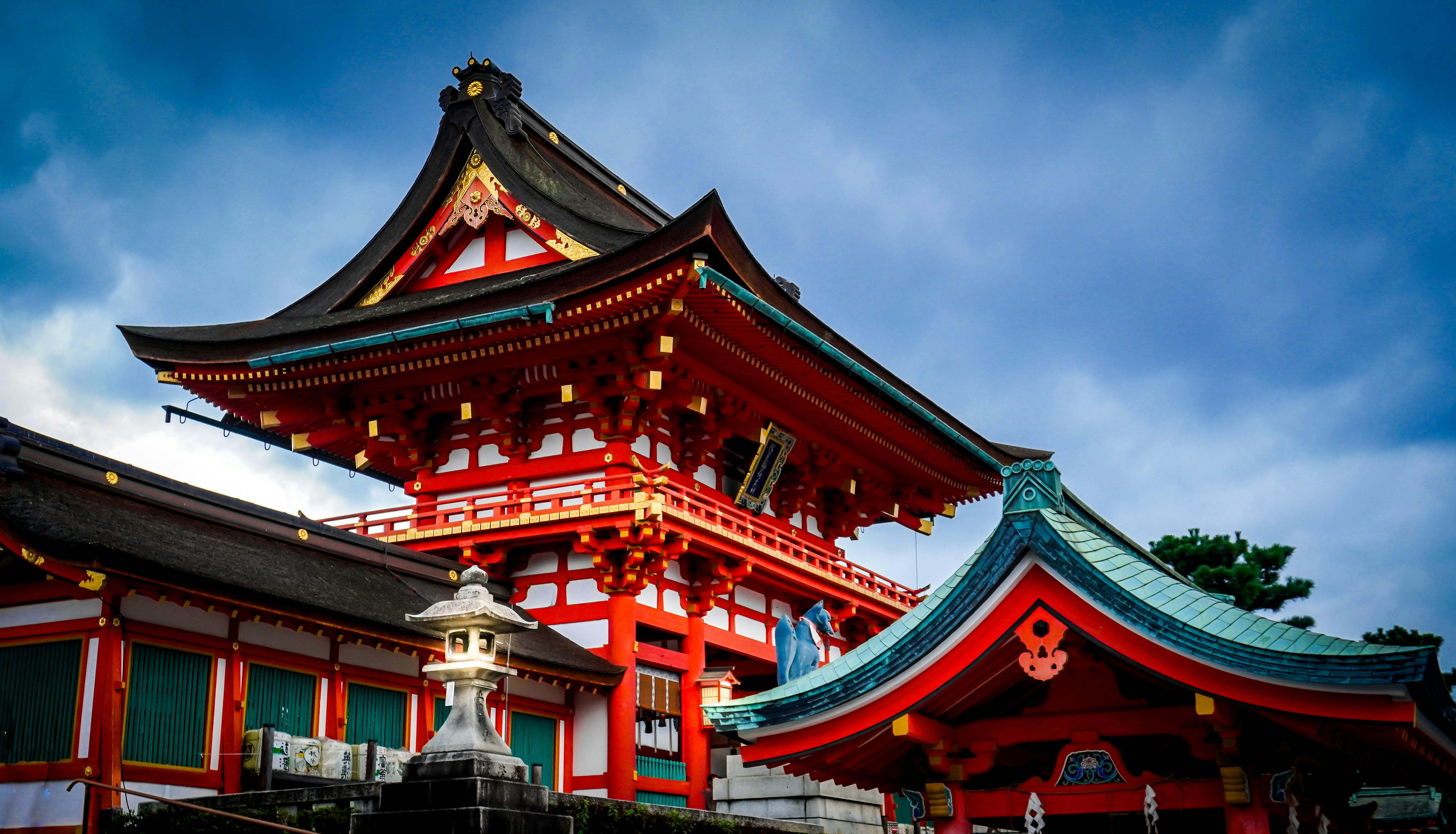red and brown temple under gray sky, A centuries old shrine gazes from the hilltop.