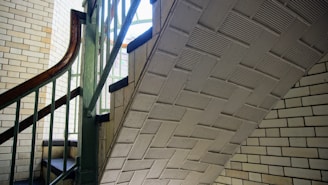 Finished staircase with brick walls and metal handrails blending craftsmanship