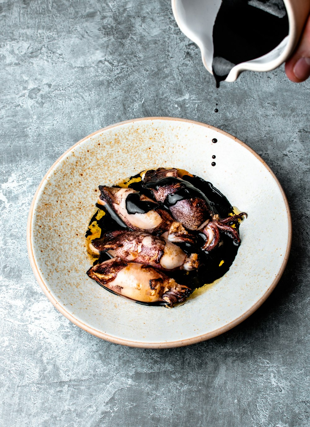 brown and black dish on white ceramic plate