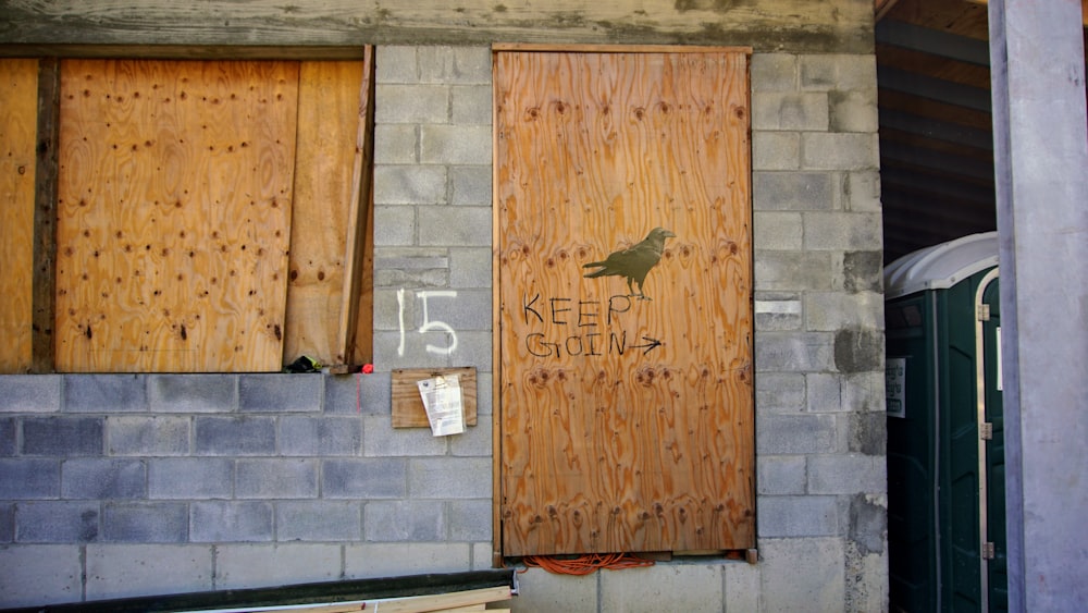 brown wooden door with i love you print