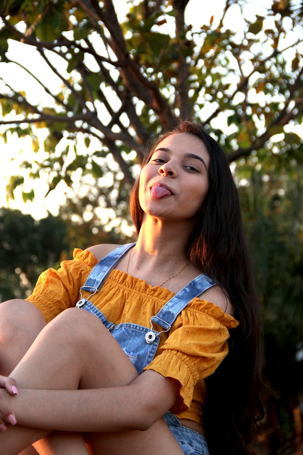 a woman sitting on the ground with her legs crossed