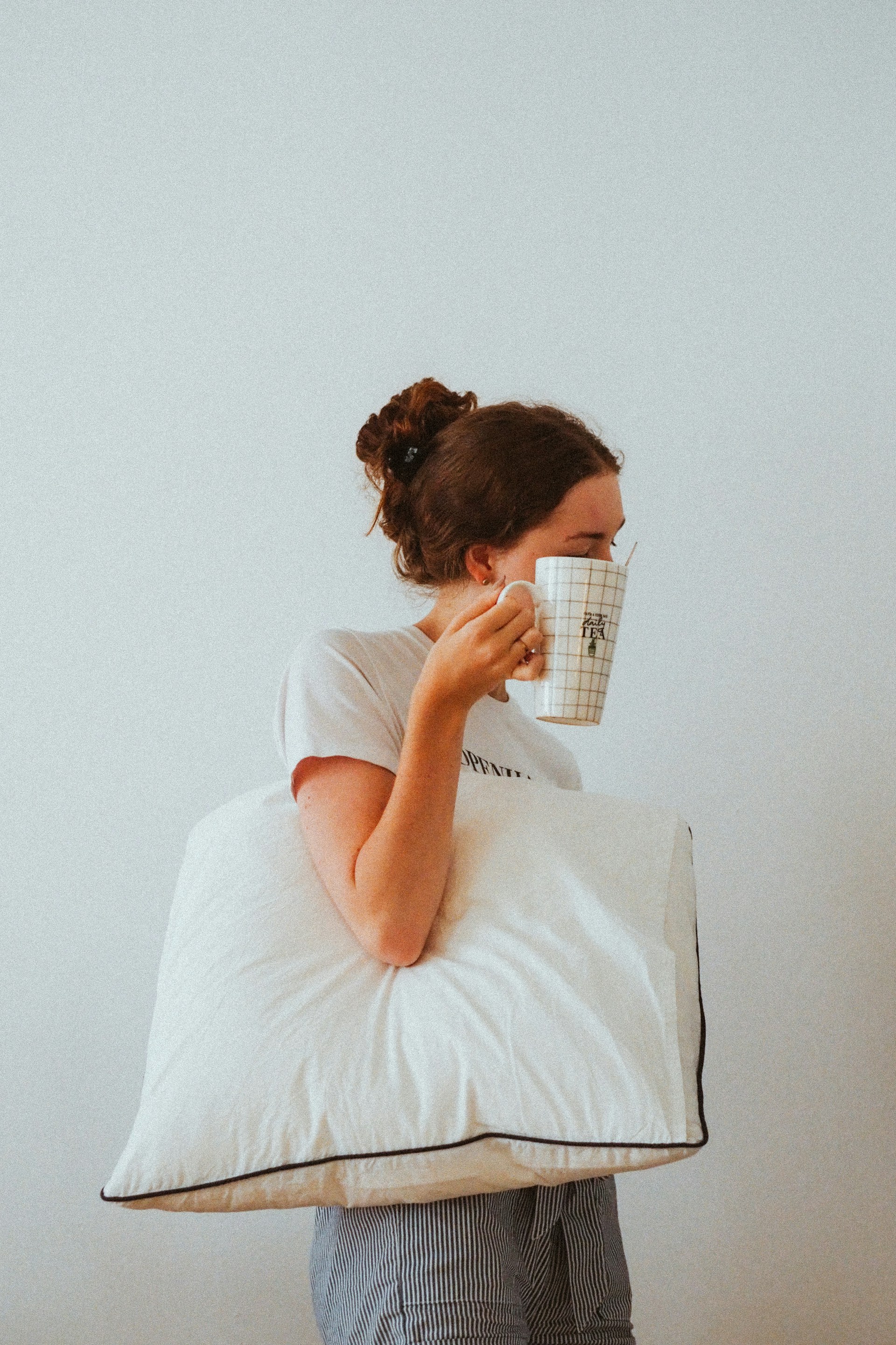 woman in white t-shirt reading book