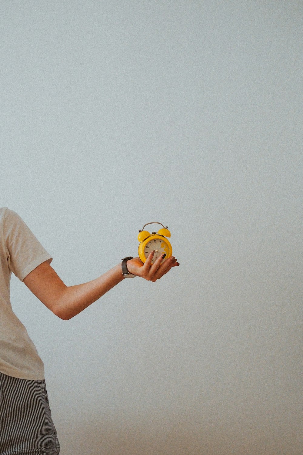 person holding yellow and white plastic toy