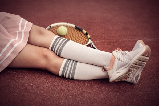 person wearing white low top sneakers