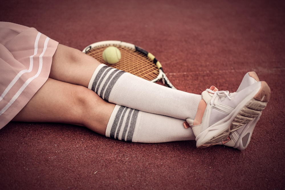 person wearing white low top sneakers