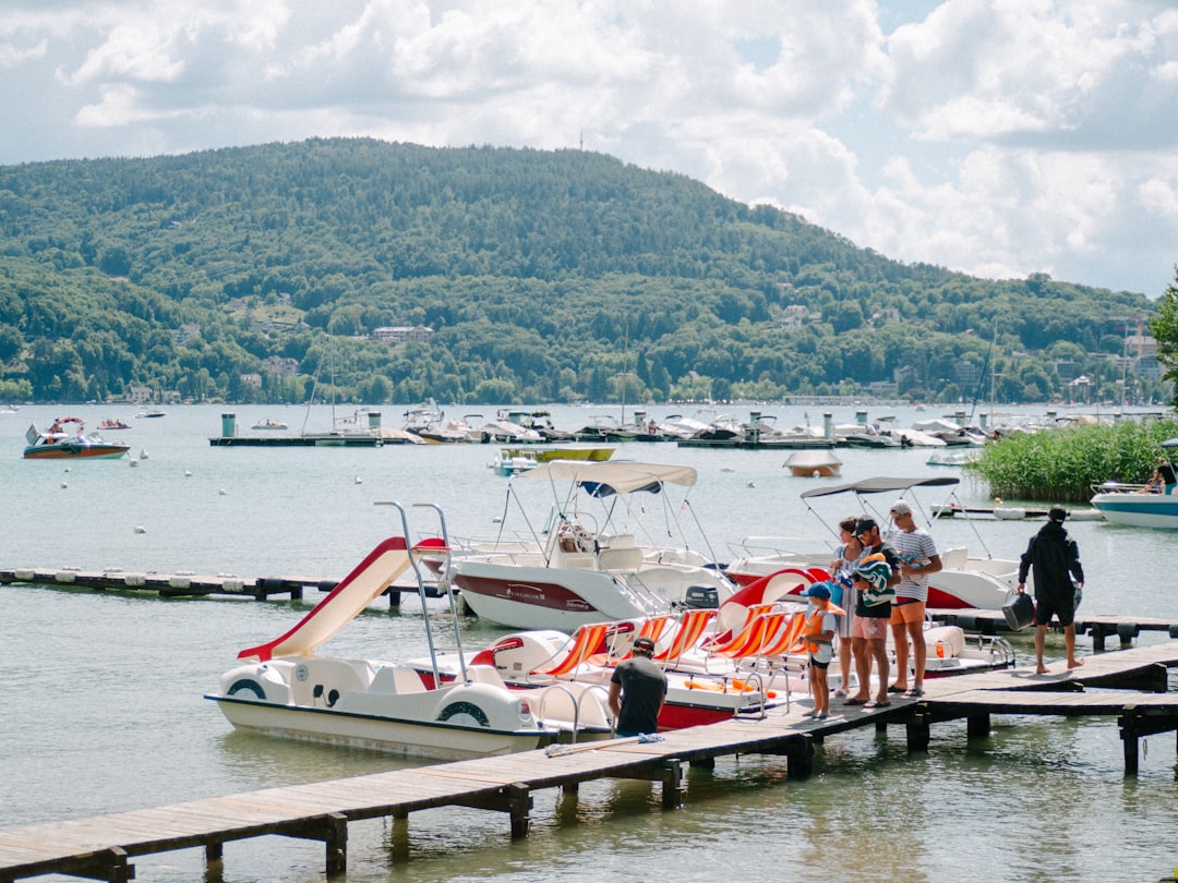 people riding on red and white boat on river during daytime