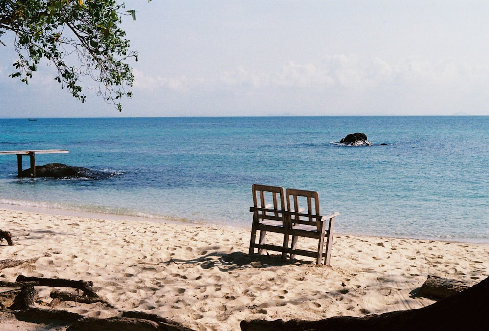 brown wooden bench on beach during daytime