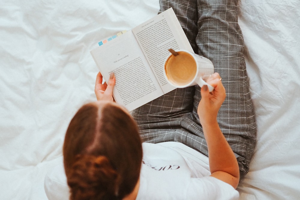 boy in white t-shirt reading book