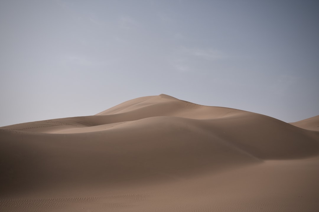 brown desert under white sky during daytime