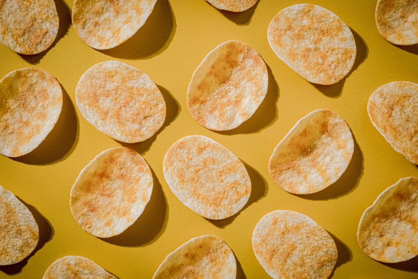 Crisps laid out on a yellow surface