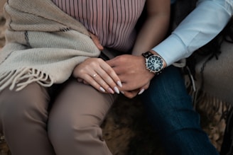 person wearing silver link bracelet round analog watch