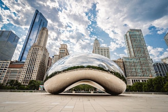 white and blue round structure in front of city buildings during daytime