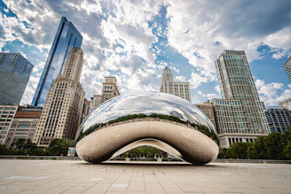 white and blue round structure in front of city buildings during daytime