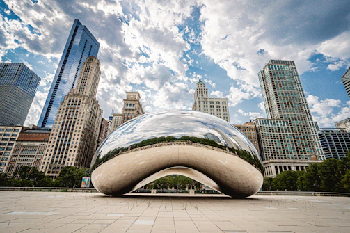 white and blue round structure in front of city buildings during daytime
