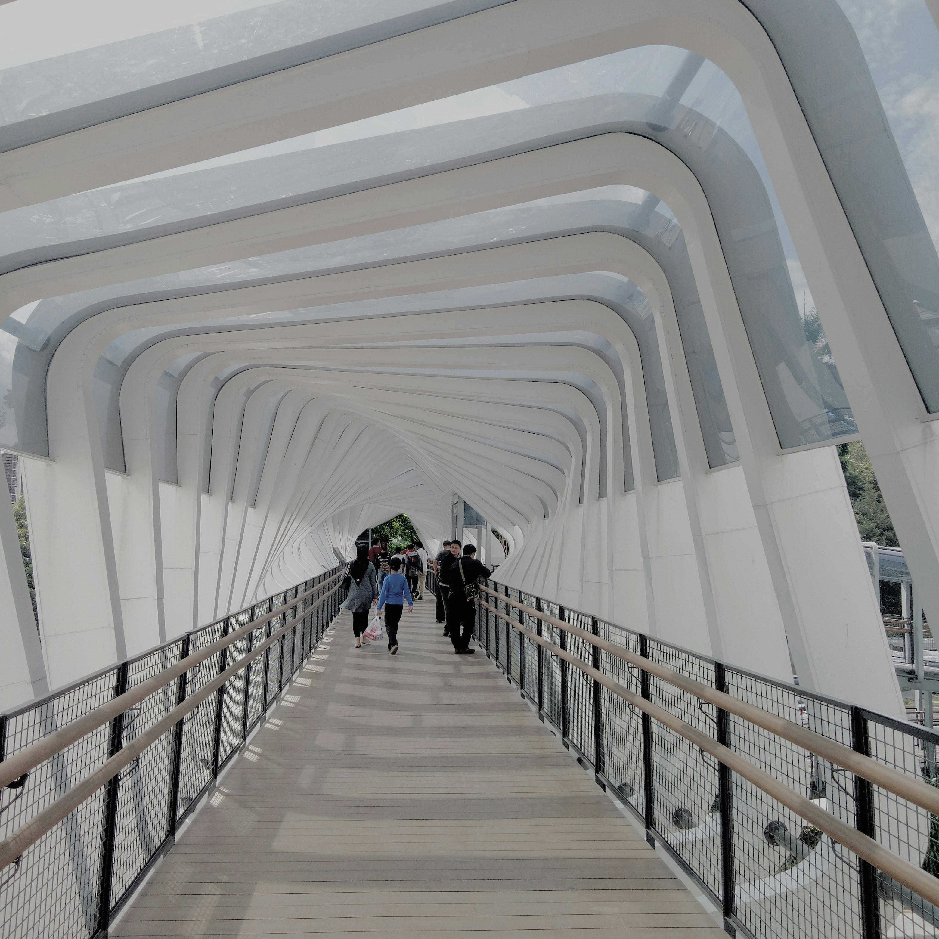 people walking on brown wooden bridge during daytime