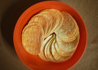 brown and white shell on orange round plate