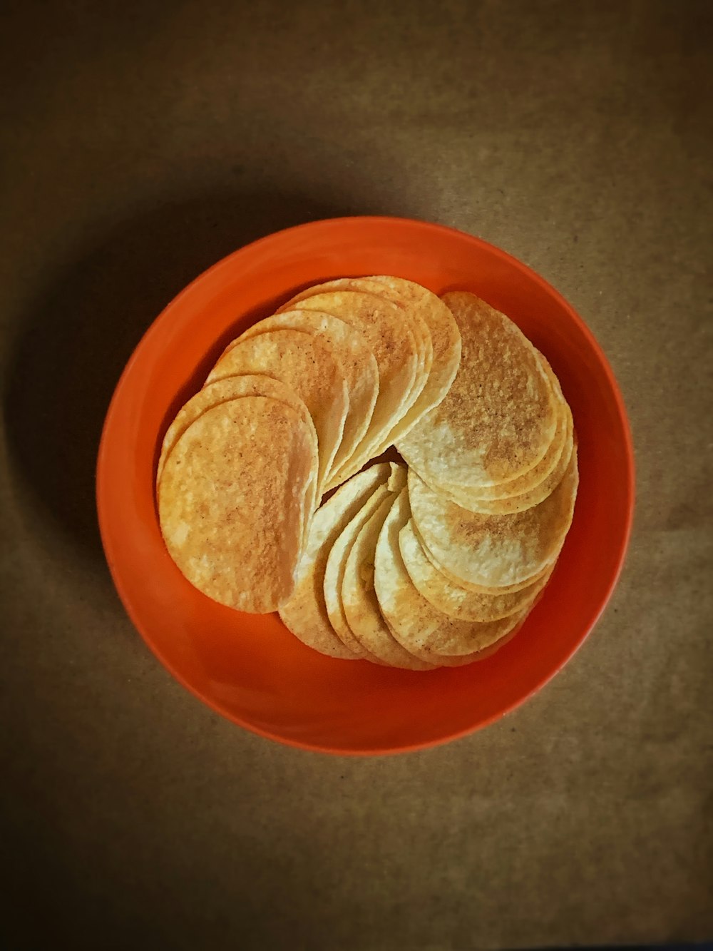 brown and white shell on orange round plate