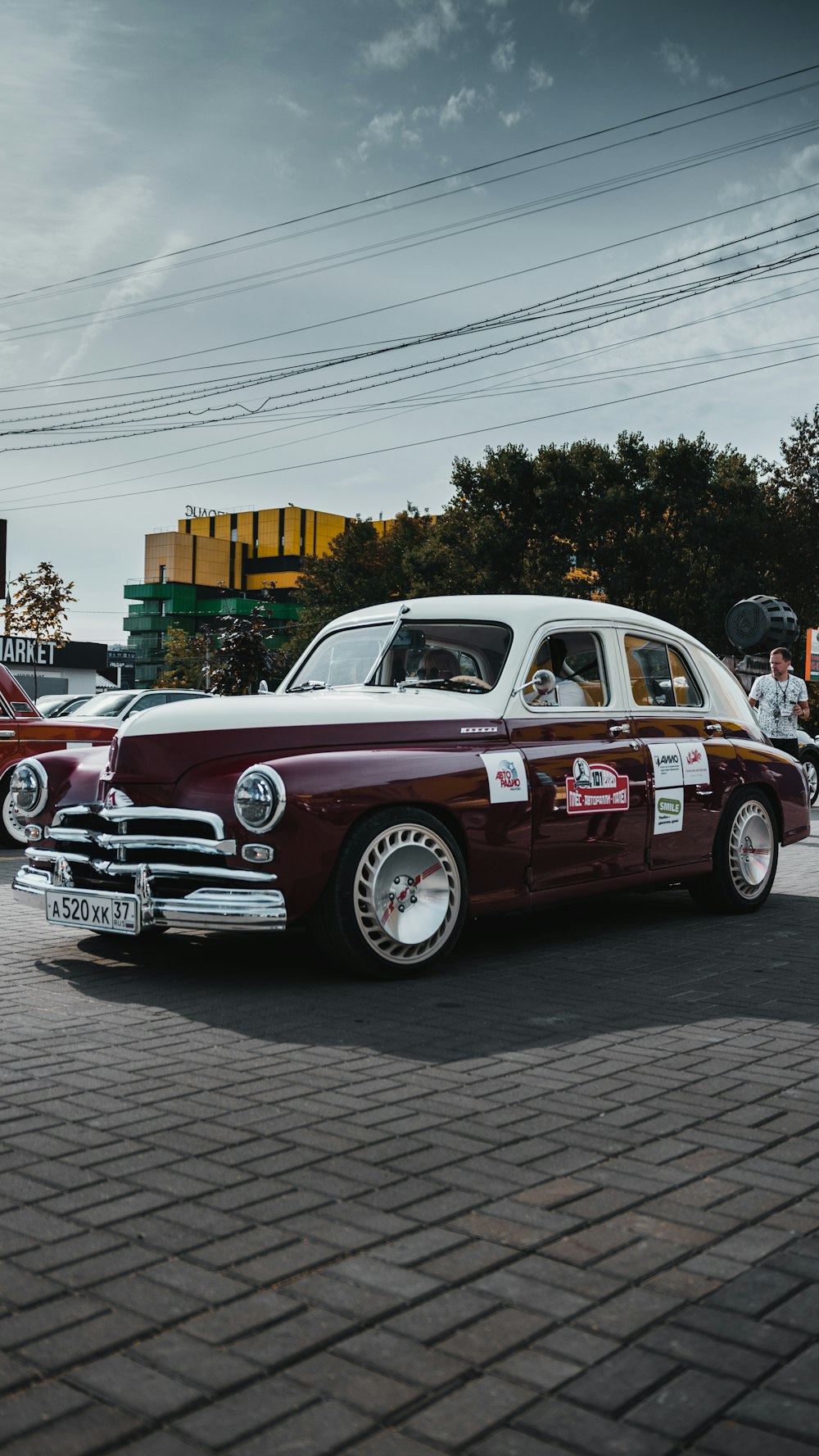 red and white classic car on road during daytime