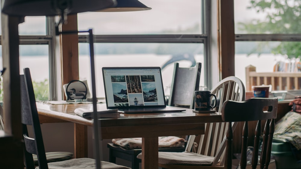 macbook pro on brown table