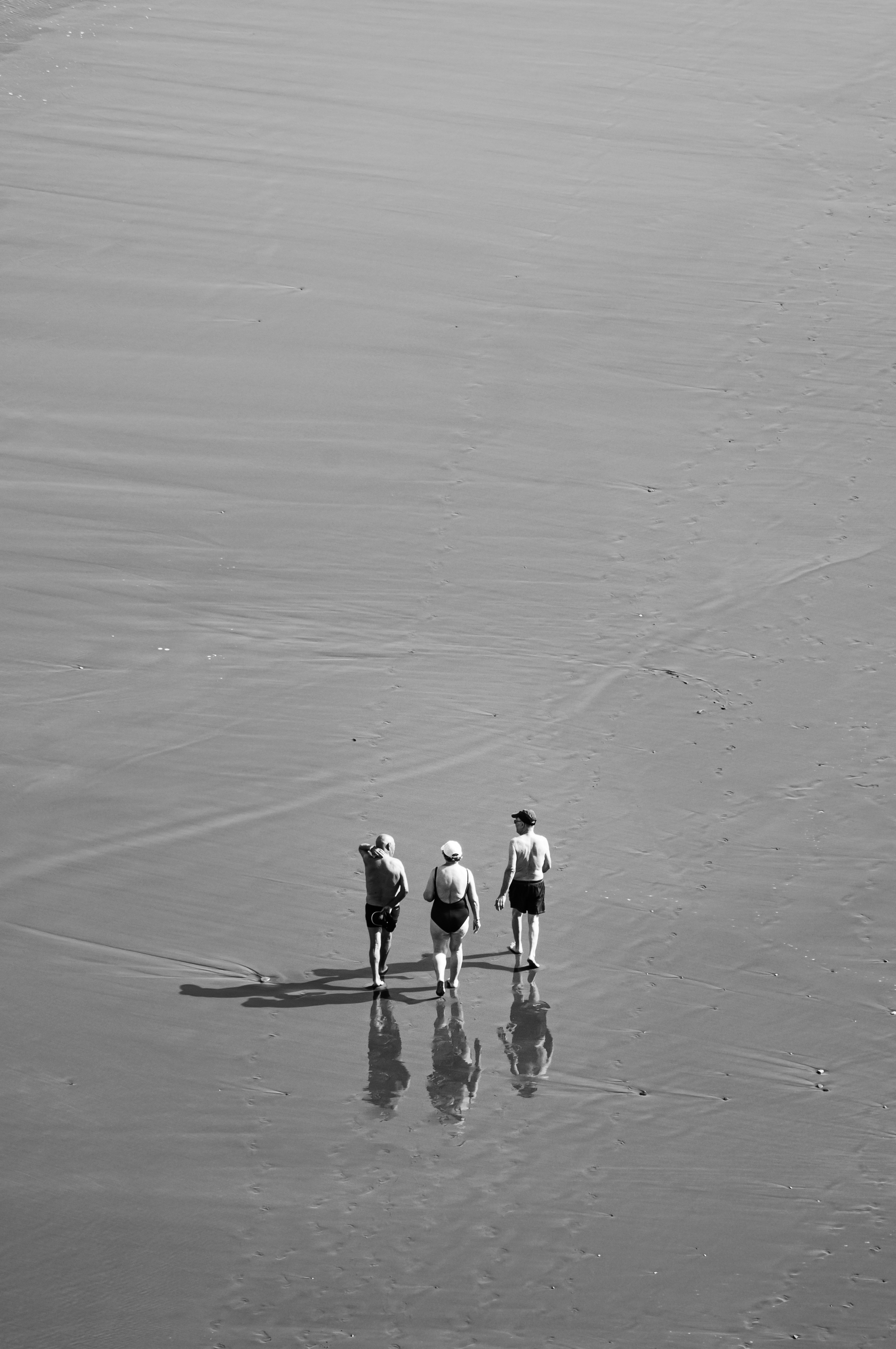 2 men walking on the beach