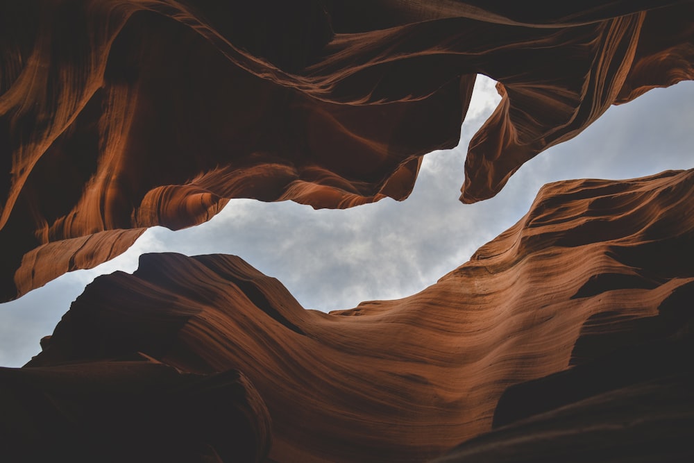 brown rock formation under white clouds during daytime