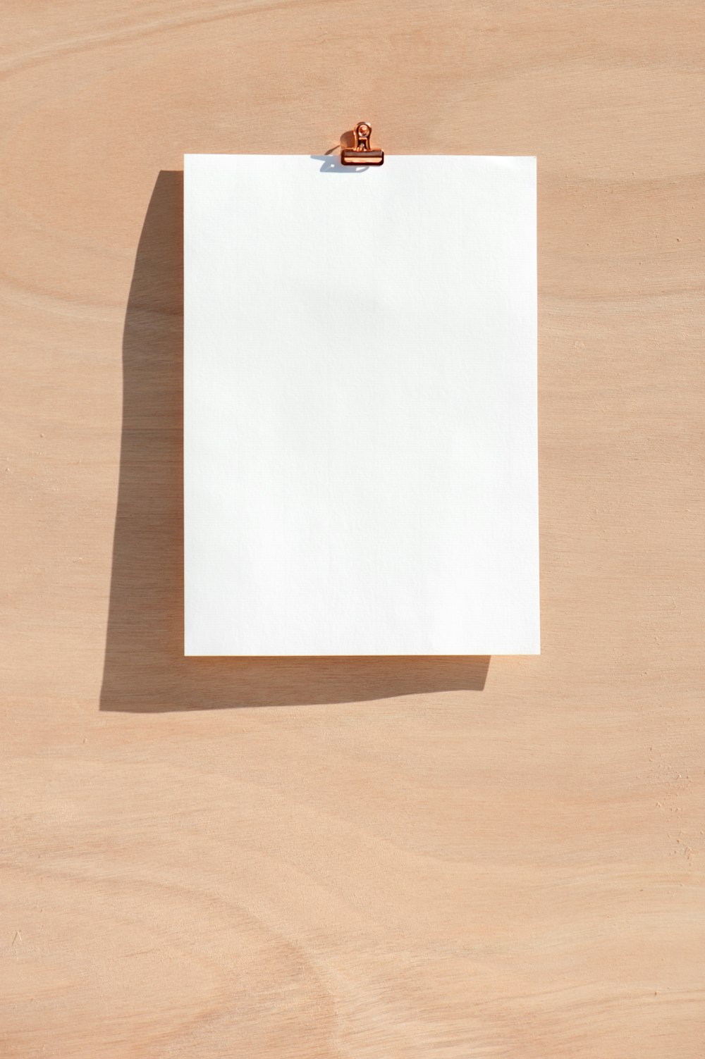 茶色の木製のテーブルに白いプリンター用紙