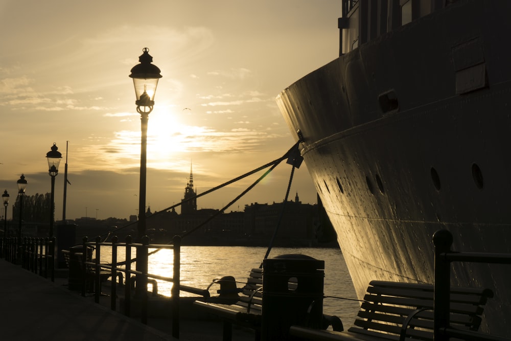 silhouette of ship on sea during sunset