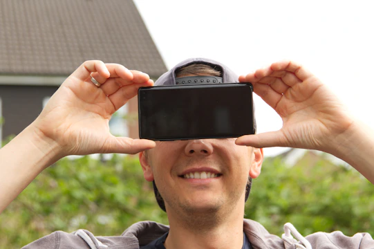 Close-up of a user smiling while navigating a Mintiva app on an Android device outdoors.