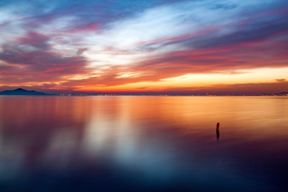 calm sea under blue sky during sunset