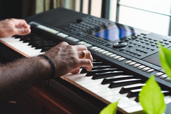 person playing black and white electric keyboard