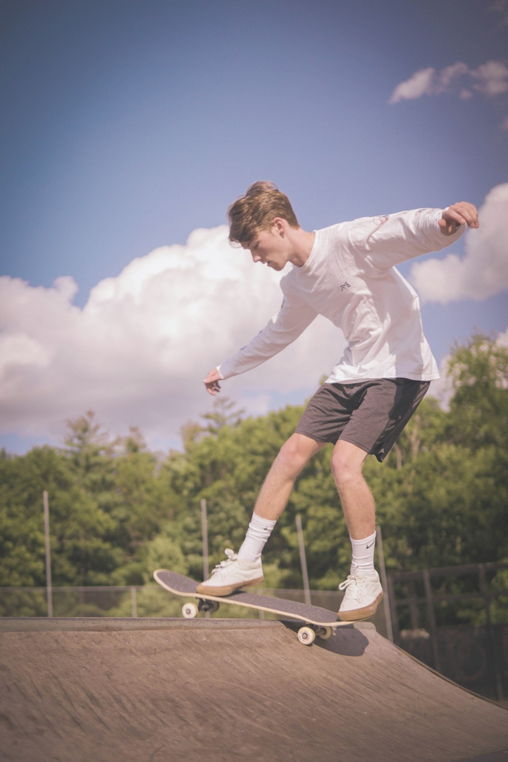 a man riding a skateboard on top of a ramp