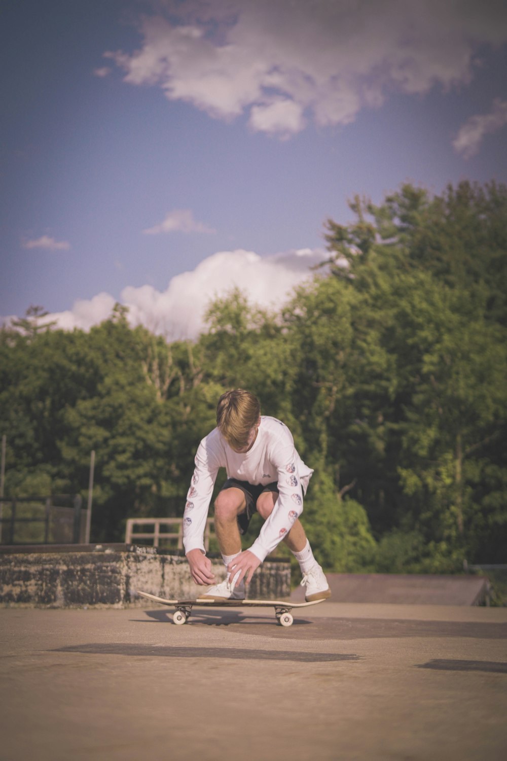 man in white long sleeve shirt riding on bicycle during daytime