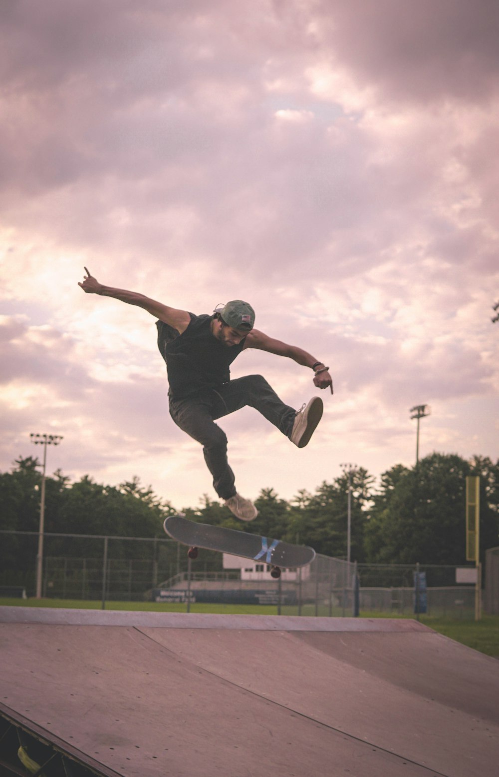 man in black t-shirt and black pants jumping on mid air during daytime