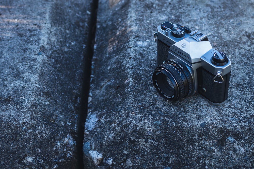 black and silver dslr camera on black and white marble table