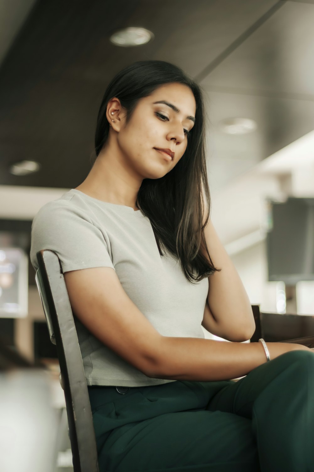 woman in white crew neck t-shirt sitting on chair