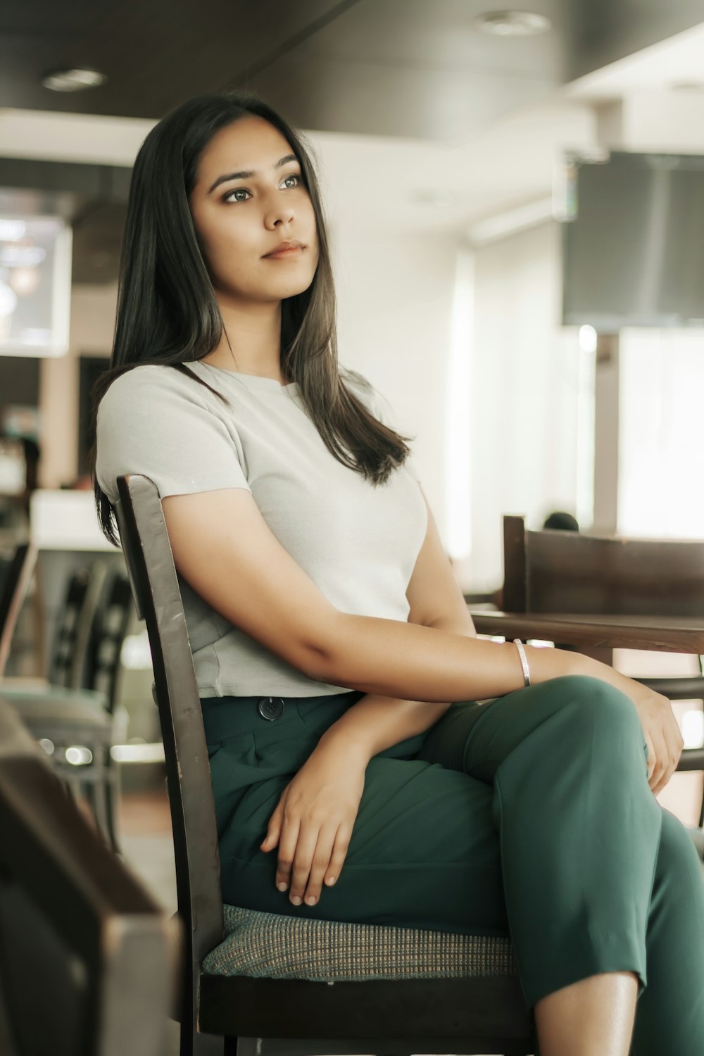 woman in white crew neck t-shirt sitting on chair